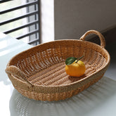 Classic oval-shaped storage basket crafted from plastic rattan with handles, ideal for versatile home organization.